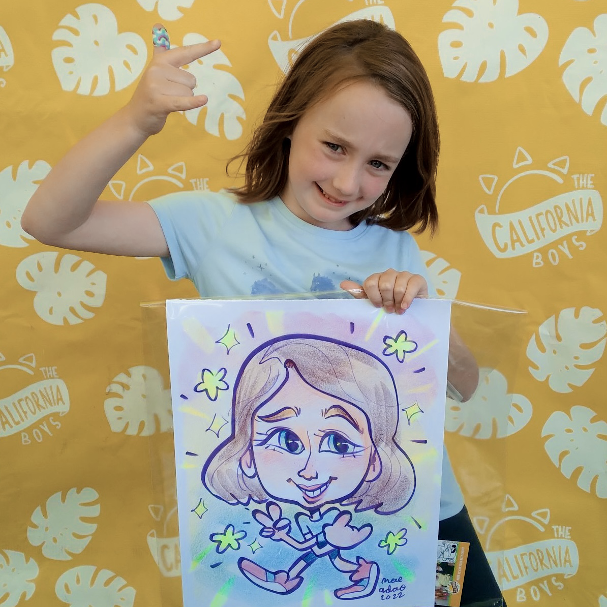 A little girl posing with her caricature