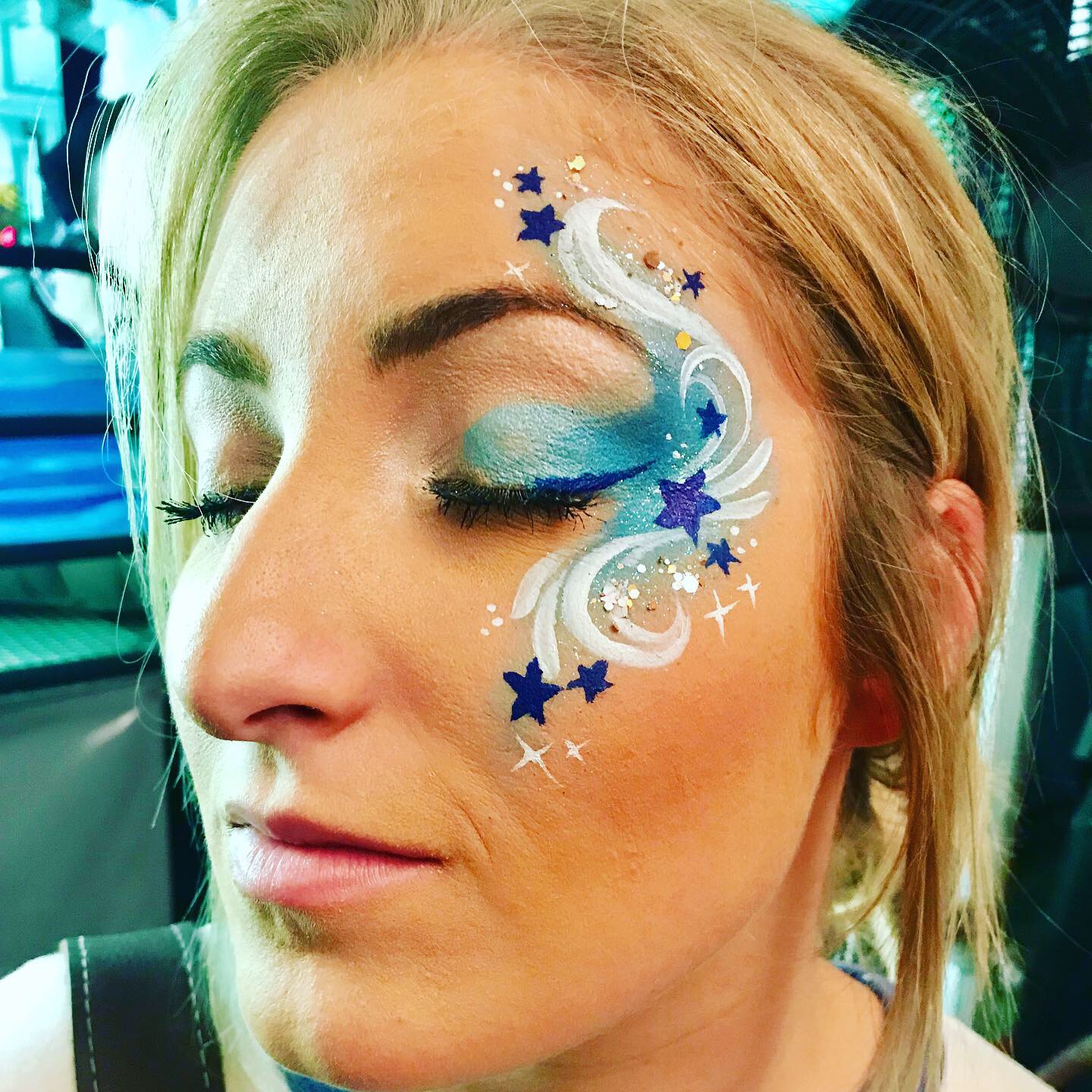 Swirly blue star adult face painting