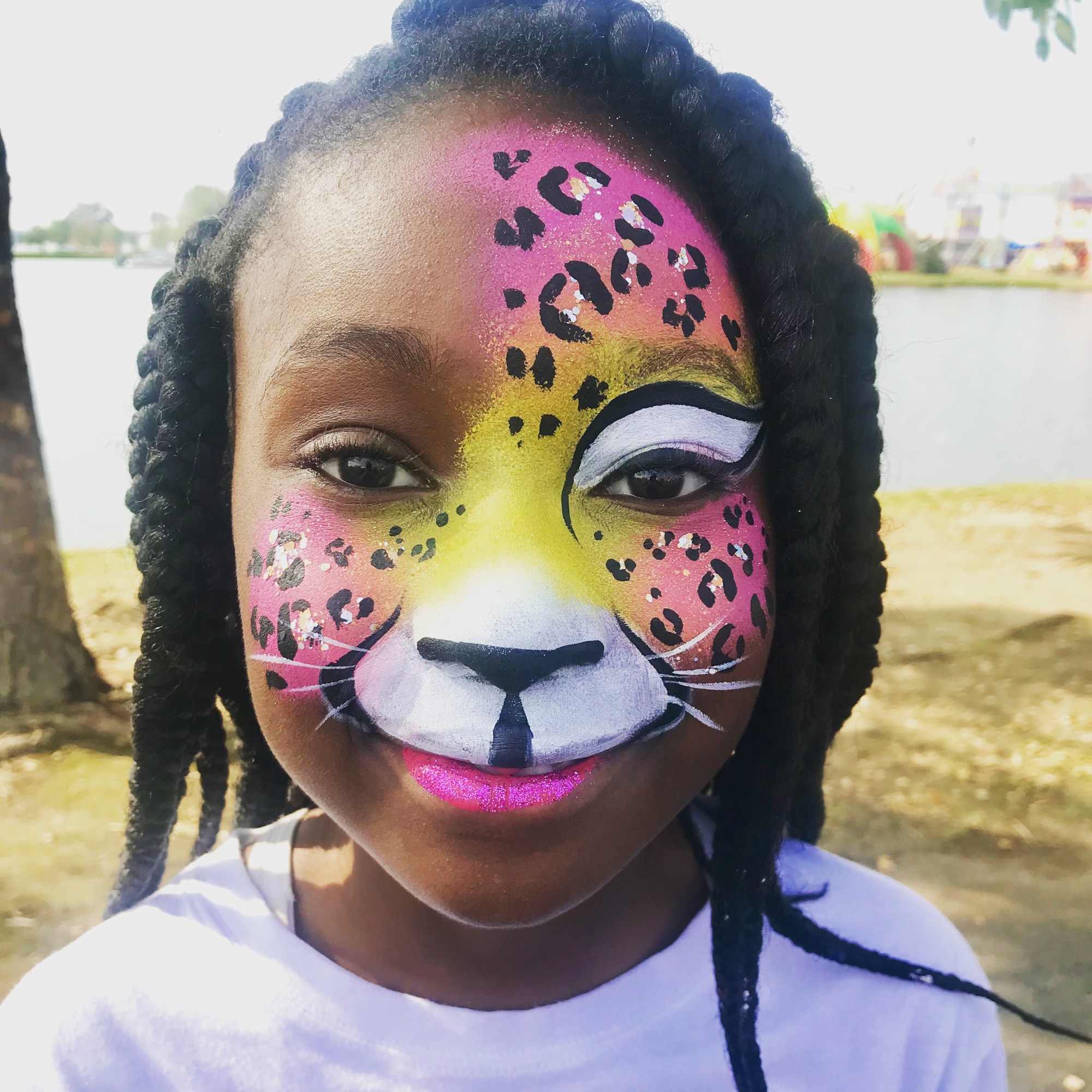 A yellow and pink leopard face paint