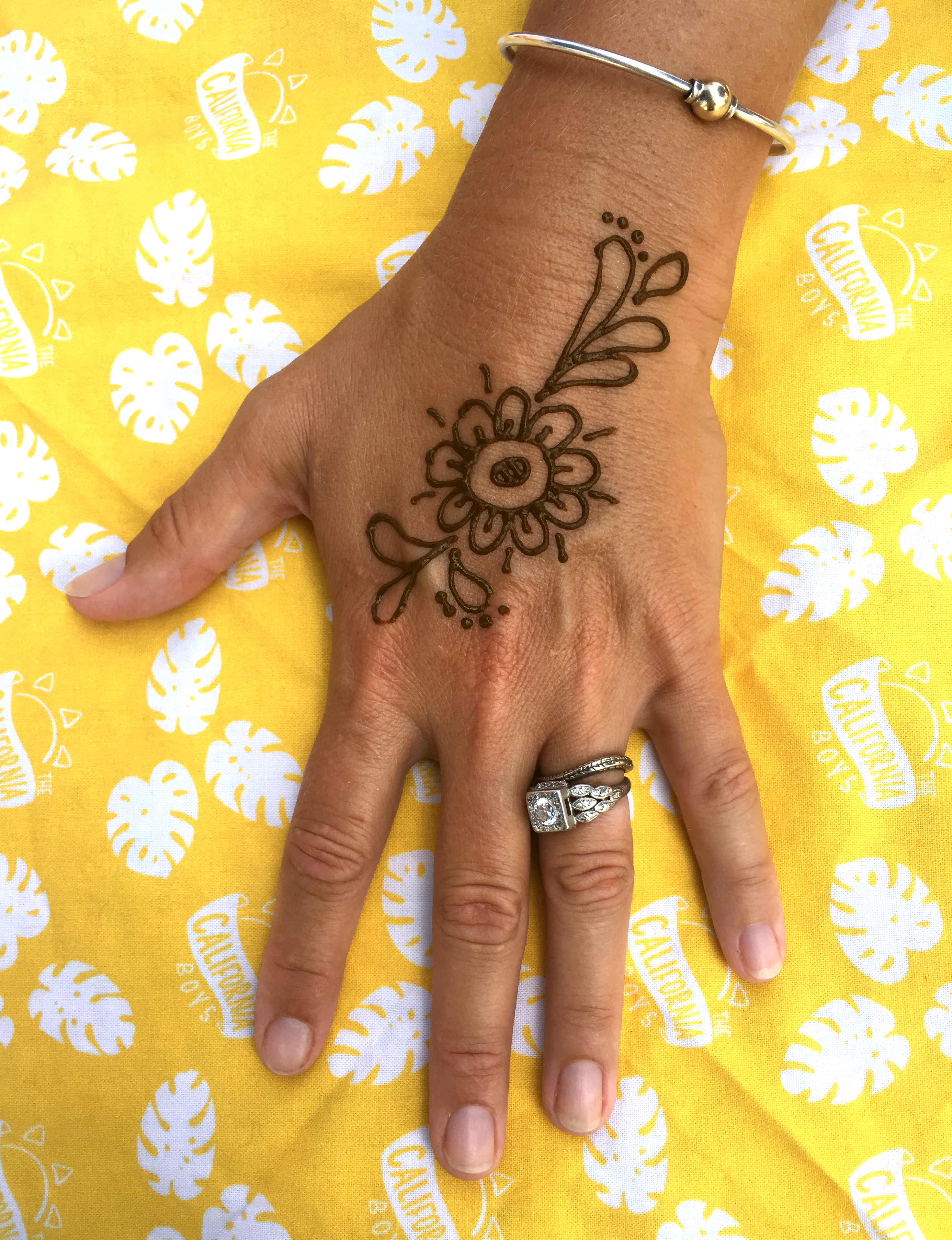 A simple flower henna tattoo on the hand