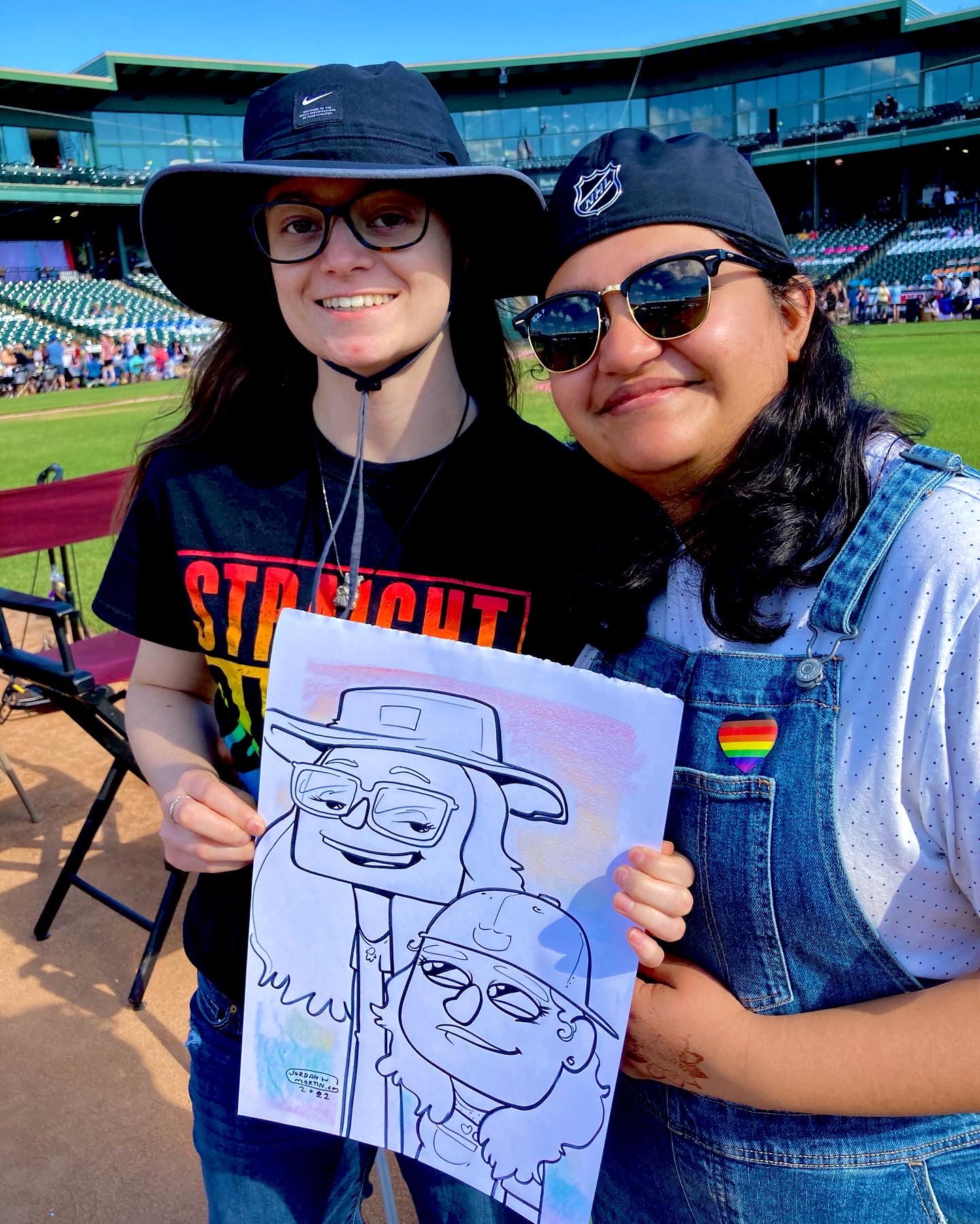 A couple posing with their caricature at Lancaster Pride