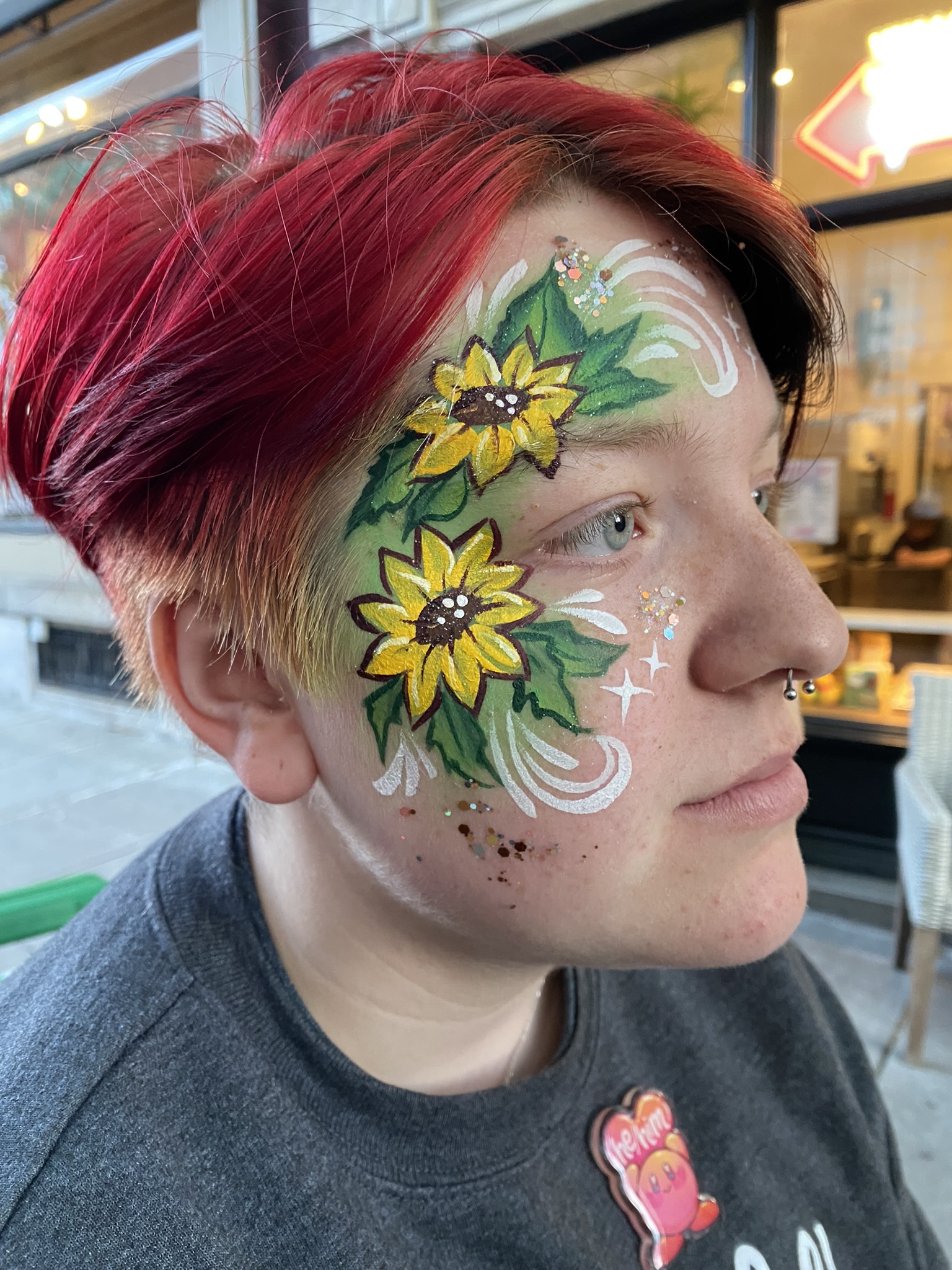 A sun flower themed face paint design