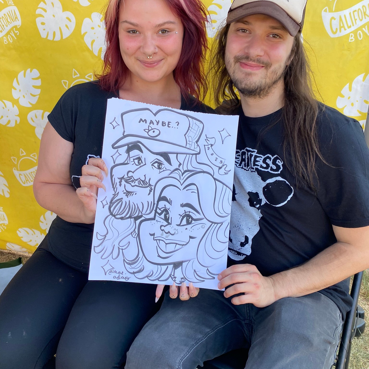A couple posing with their caricature
