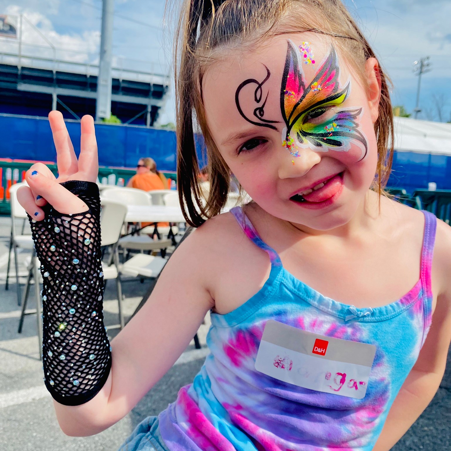 A neon rainbow butterfly face painter