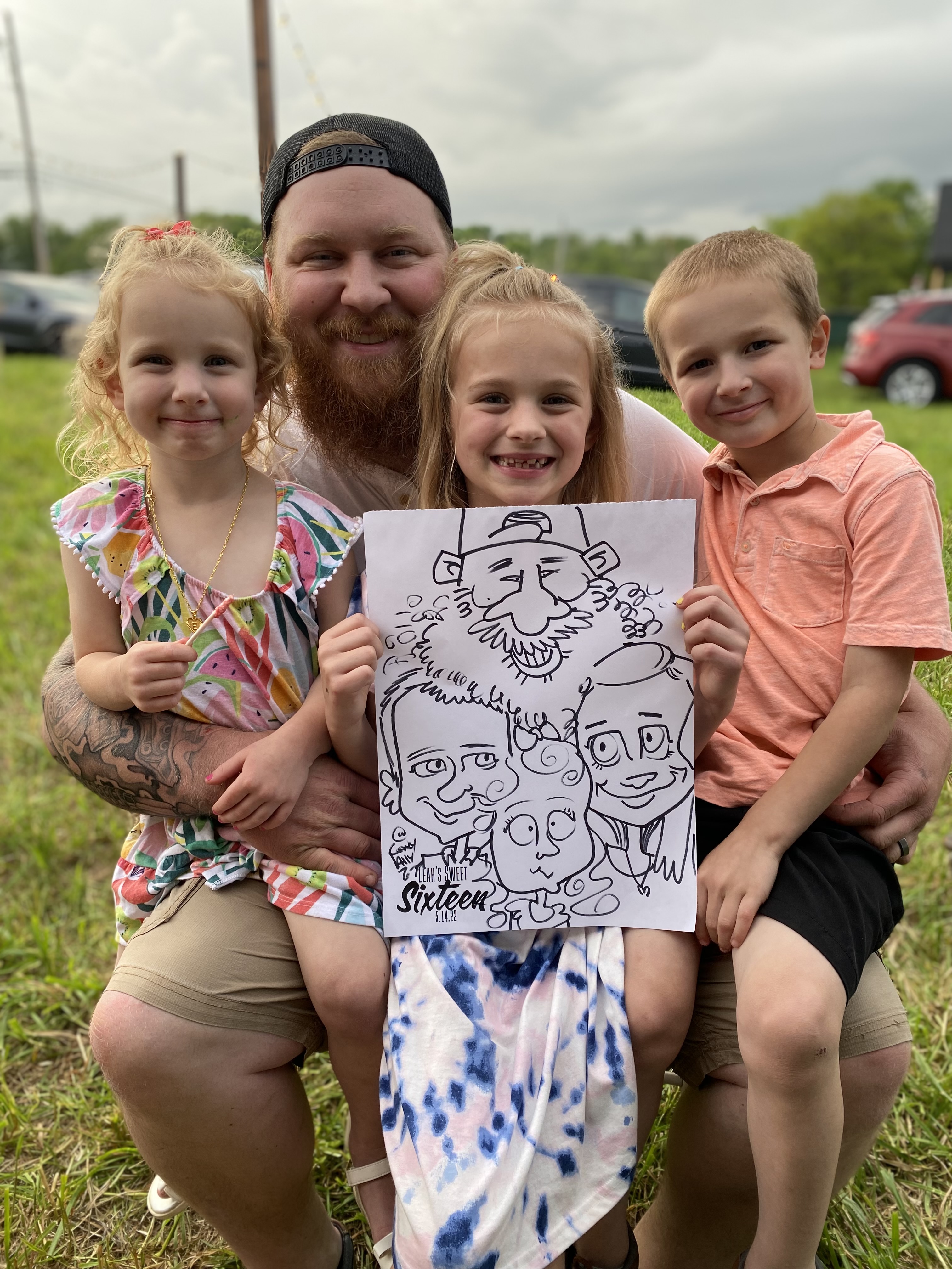 A family of 4 posing with their caricature