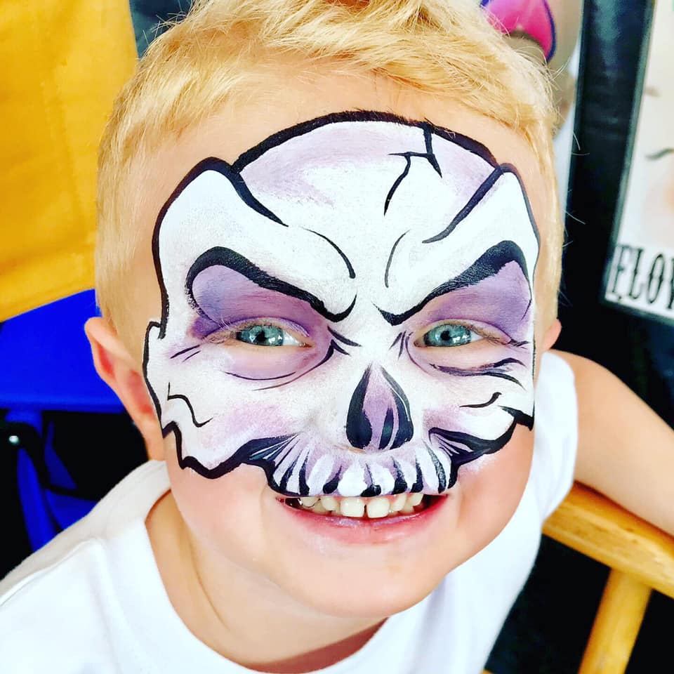 A skull design face paint on a little boy