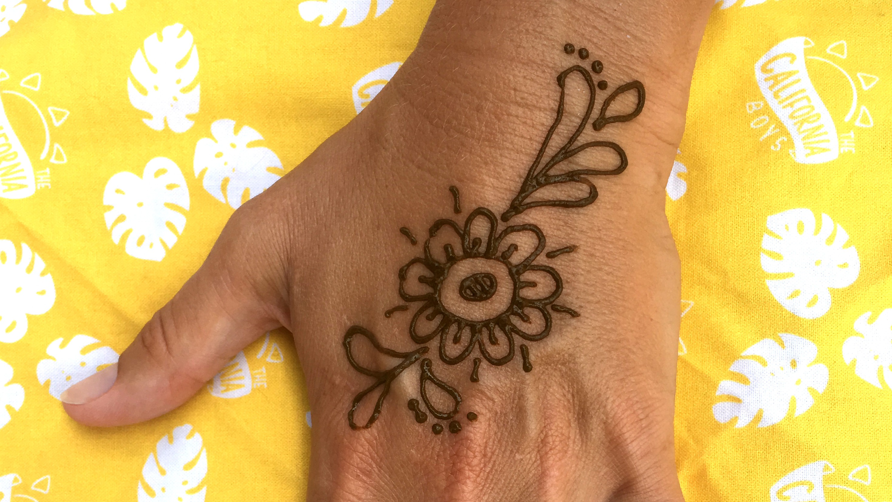A simple flower henna tattoo on the hand