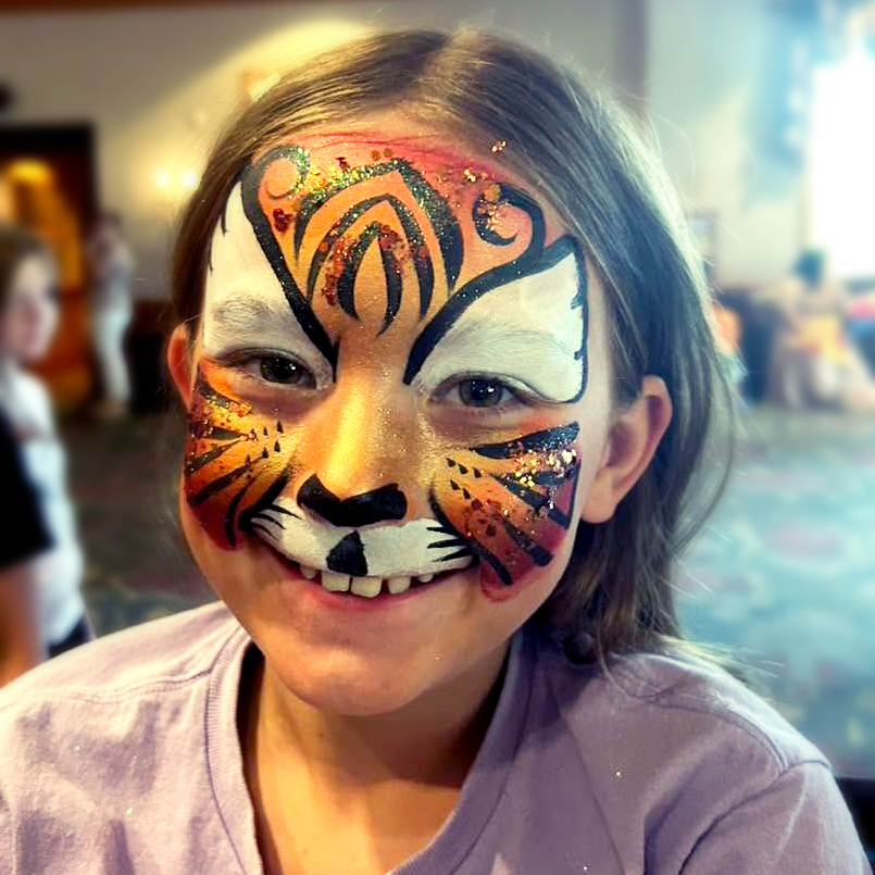 A sparkly tiger face paint